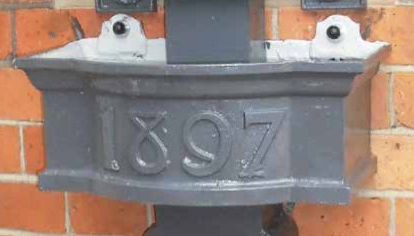 Cast iron hopper head cast with the date 1897