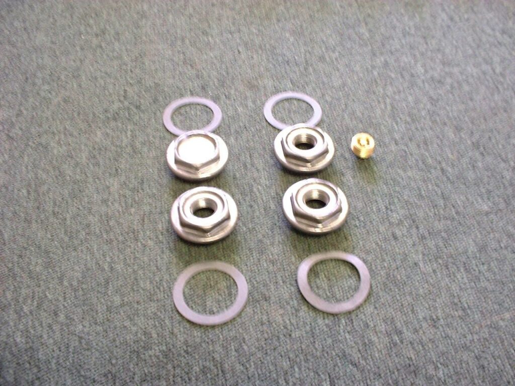 Radiator nipples, washers and fittings laid out for assembling cast iron radiator sections