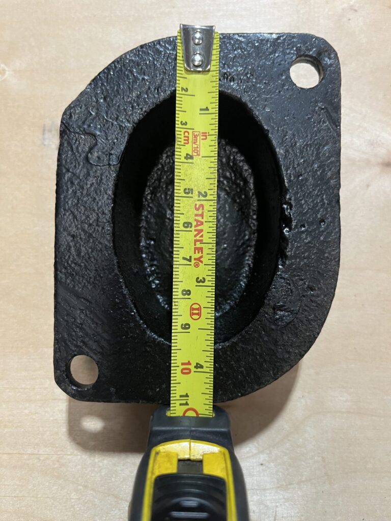 Tape measure across the outlet of a cast iron hopper head to record its size