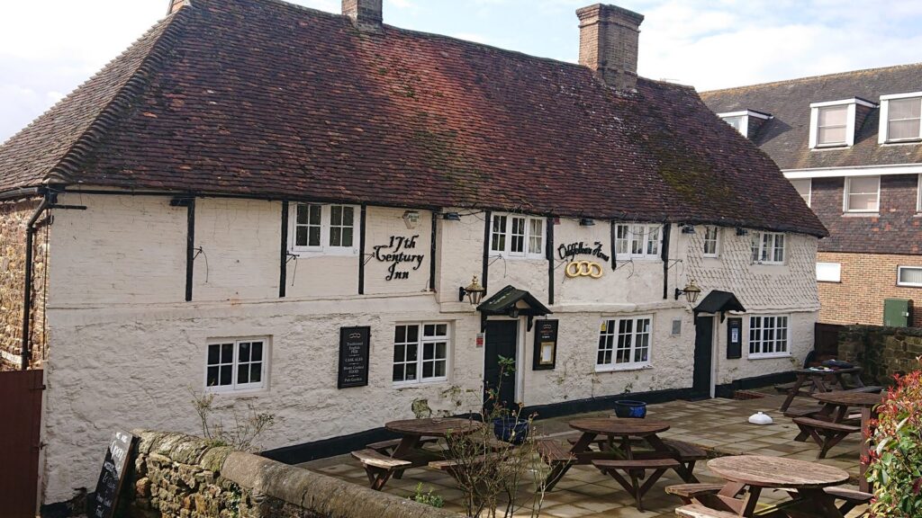 Seventeenth-century tile-hung inn with black guttering at the eaves