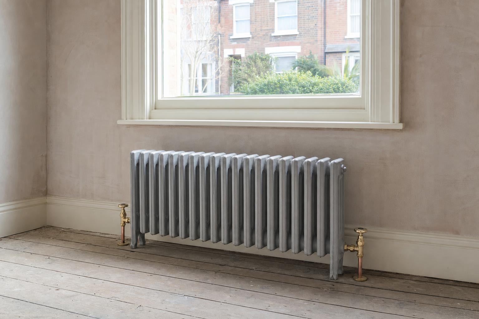Victorian four-column cast iron radiator, 636mm high, in primer, in a period room.